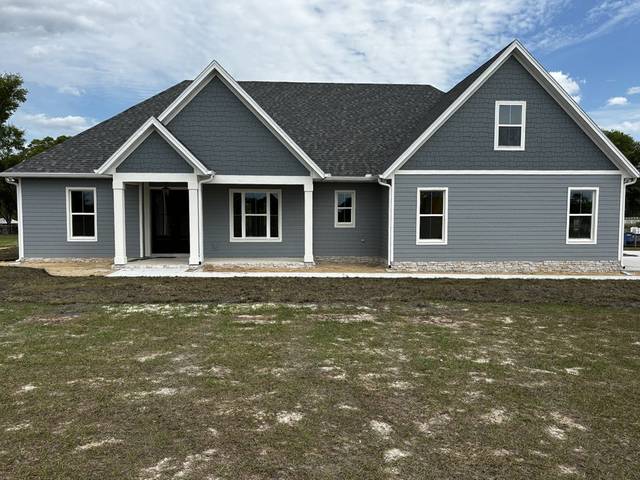 White gutters and downspouts across the front of a new blue-gray home